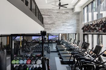 Two-story fitness center with free weights and cardio machines